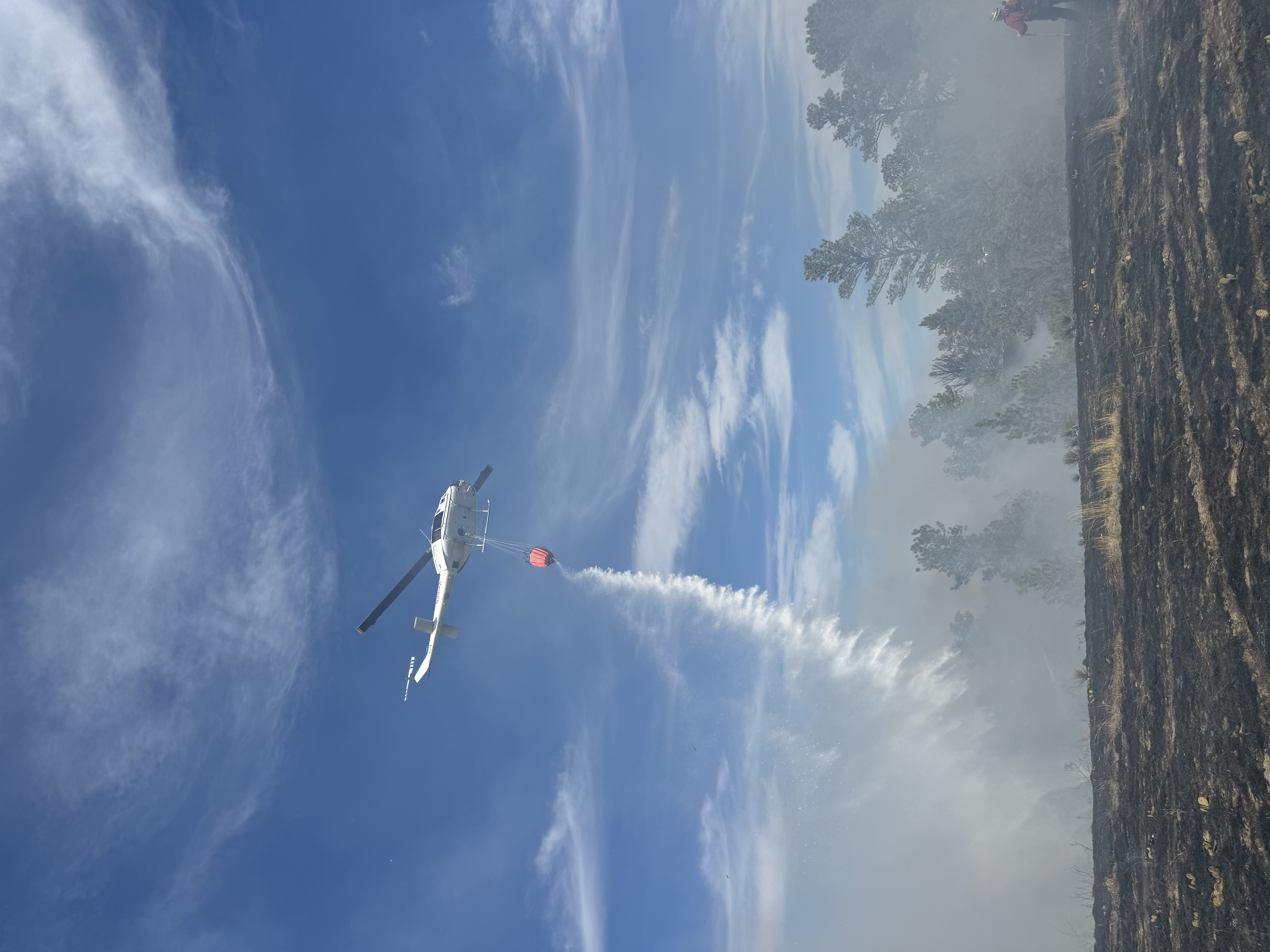 Helicopter performing bucket drops.