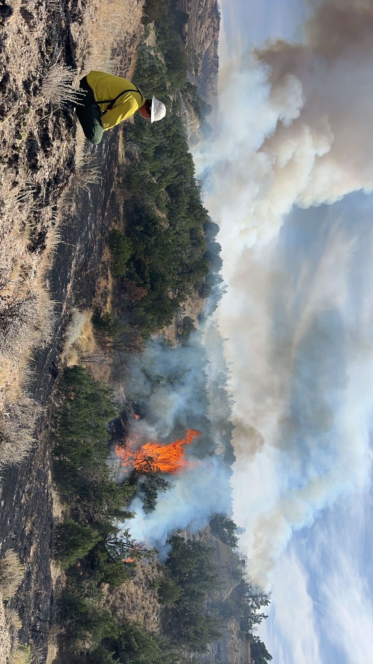 Firefighter observes active burn.